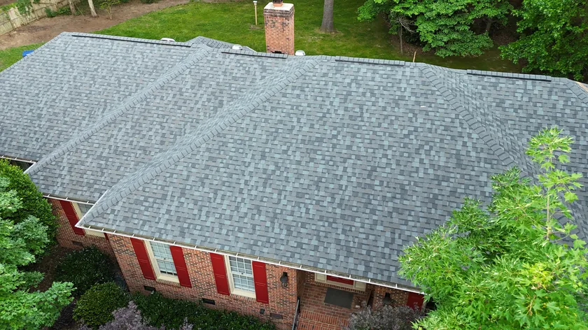 Drone view of a finished architectural shingle roof on a brick ranch home in Weddington, NC