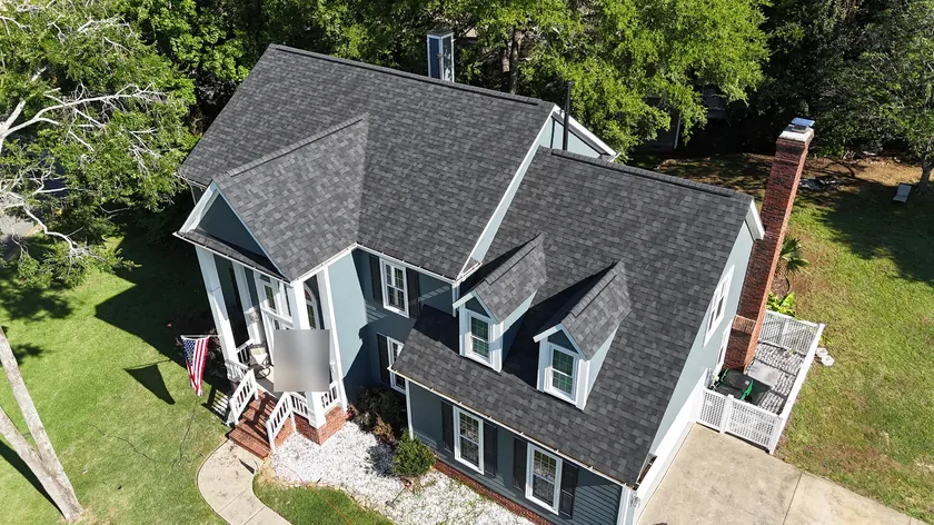 Drone view of a finished charcoal shingle roof with two dormers on a home in Ballantyne, Charlotte