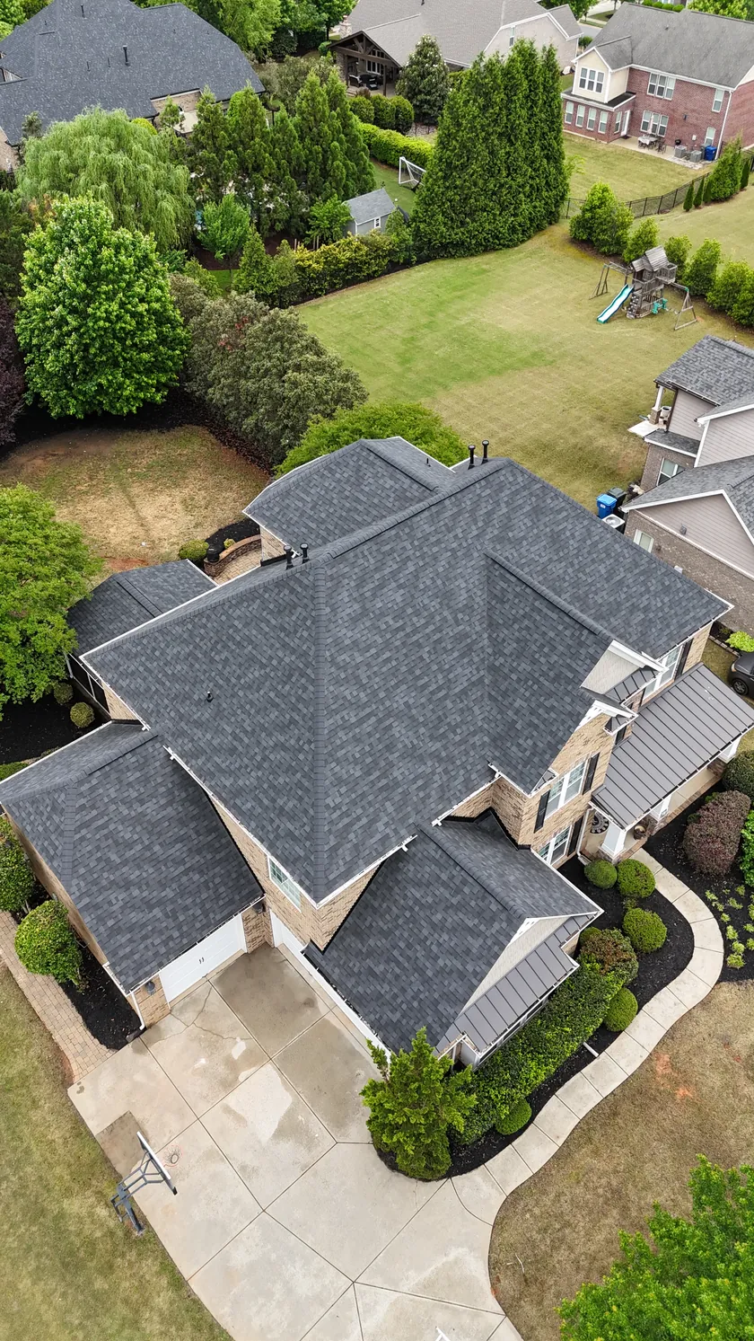 Drone view looking down on a finished charcoal shingle roof on a large home in Union County, NC